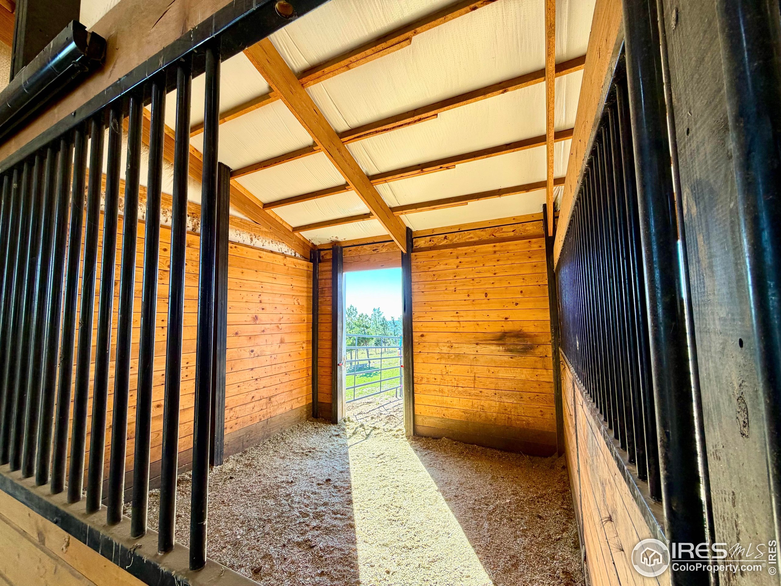 3235 Davis Ranch Road Bellvue, CO 80512 - Photo 10 of 38 a view of a porch with wooden floor and door