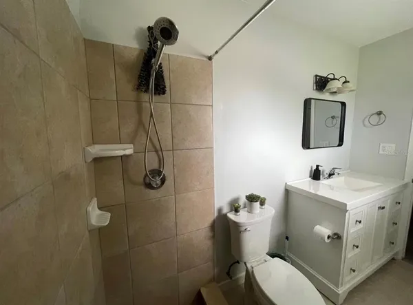 a bathroom with a toilet sink and shower