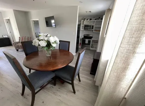 a dining room with furniture and window