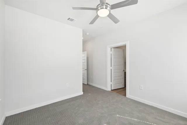 a view of a room with a fan and a window