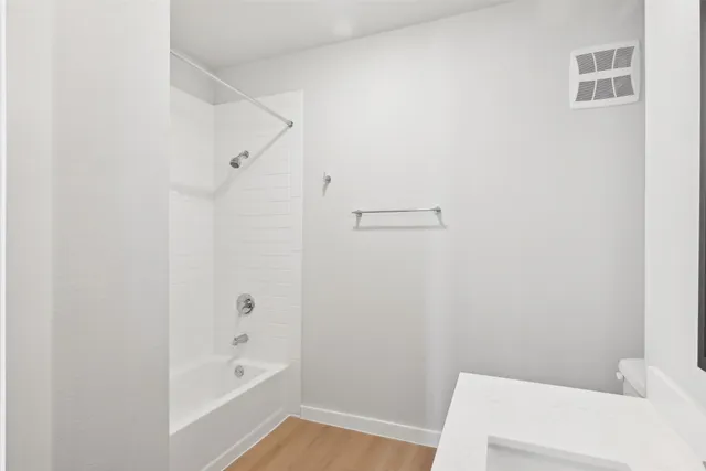 a bathroom with a bathtub and shower