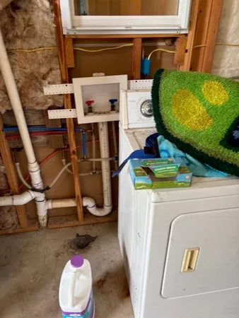 a room with water heater and refrigerator