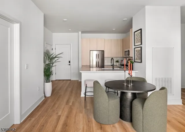 a kitchen with kitchen island granite countertop a sink and refrigerator