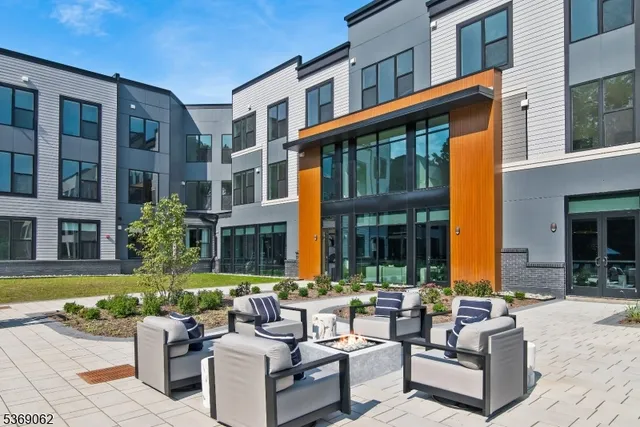 a view of a building with couches in a patio