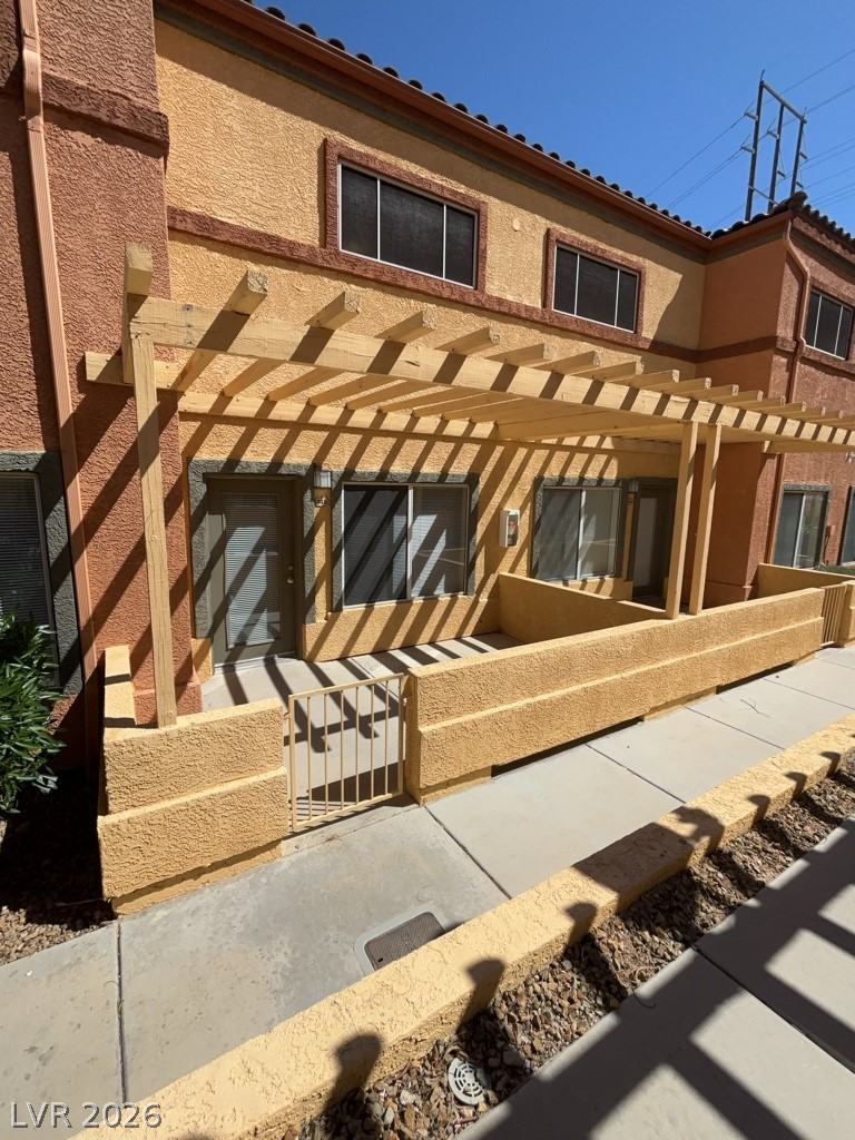 4915 East Russell Road, Unit 145 Las Vegas, NV 89120 - Photo 1 of 13 Back of property featuring a pergola