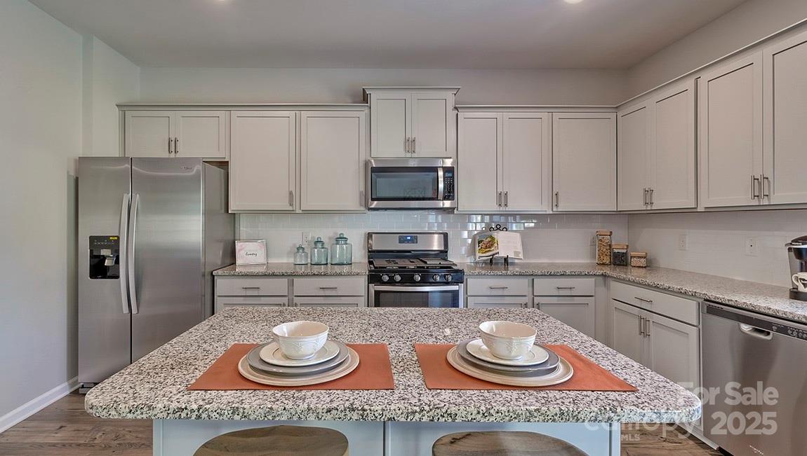 4025 Cramer Estates Gastonia, NC 28056 - Photo 16 of 36 a kitchen with granite countertop a refrigerator and stove