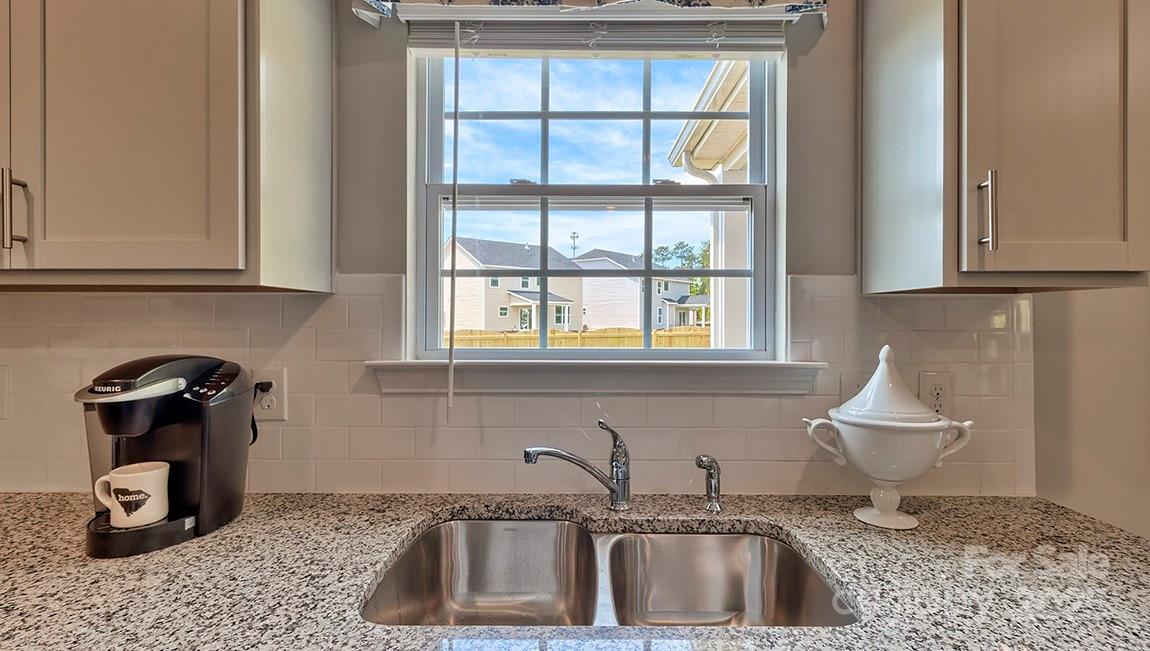 4025 Cramer Estates Gastonia, NC 28056 - Photo 18 of 36 a kitchen with a sink a window and cabinets