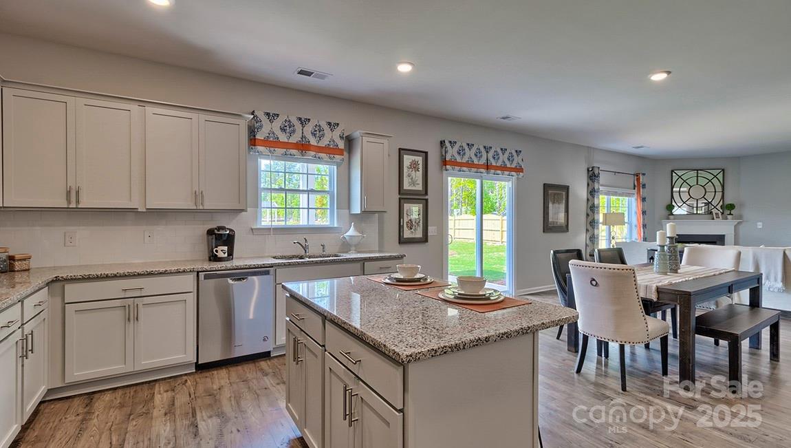 4025 Cramer Estates Gastonia, NC 28056 - Photo 19 of 36 a kitchen with granite countertop sink window and dining table