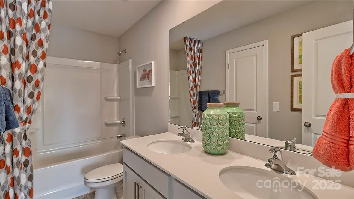 4025 Cramer Estates Gastonia, NC 28056 - Photo 28 of 36 a bathroom with a granite countertop sink and a mirror