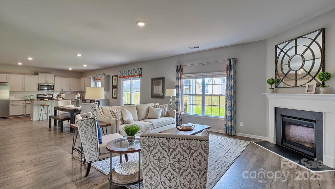 4025 Cramer Estates Gastonia, NC 28056 - Photo 10 of 36 a living room with furniture a window and a fireplace