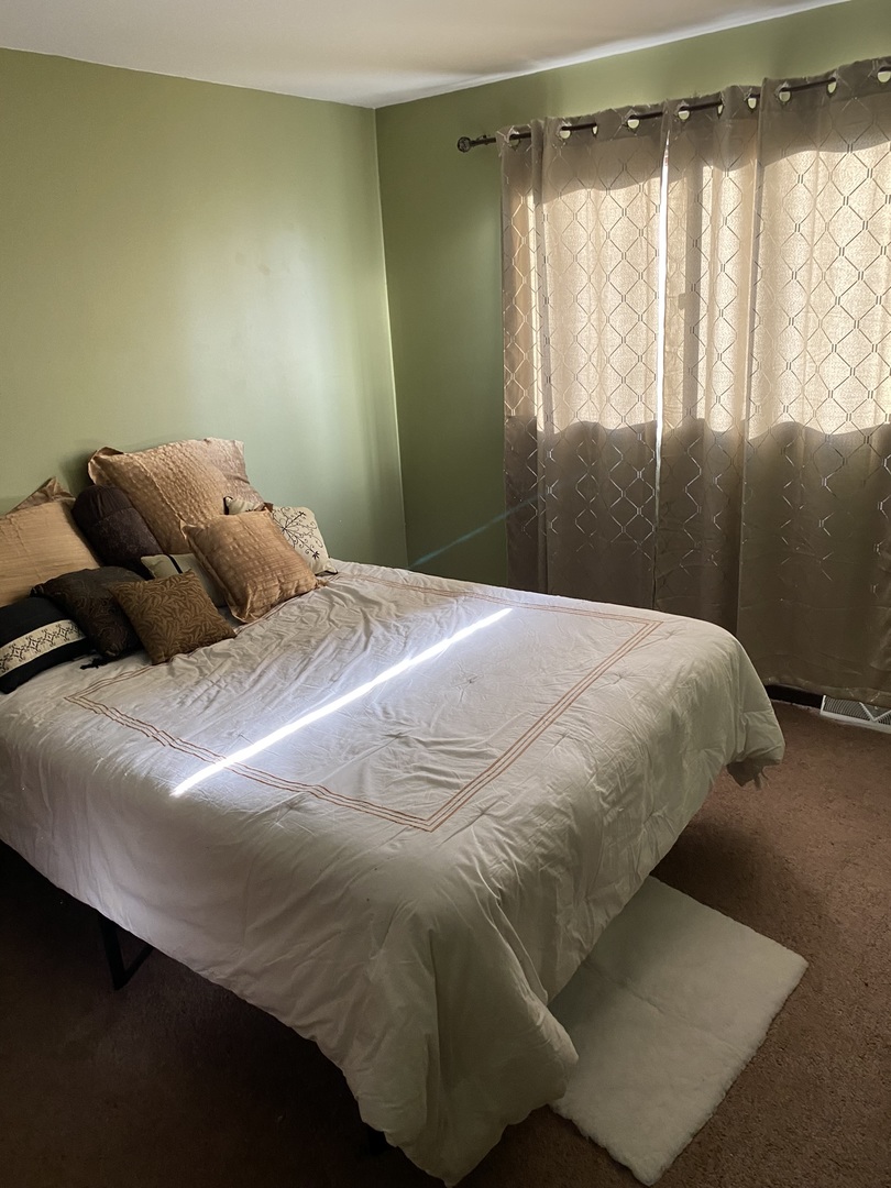 100 Michigan City Road Calumet City, IL 60409 - Photo 11 of 12 a bedroom with a bed and a window
