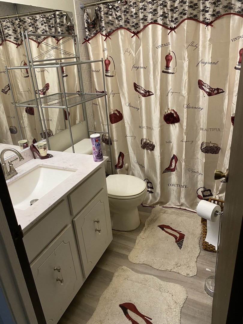 100 Michigan City Road Calumet City, IL 60409 - Photo 8 of 12 a bathroom with a double vanity sink toilet and shower