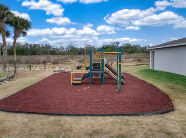 a view of a backyard with swimming pool