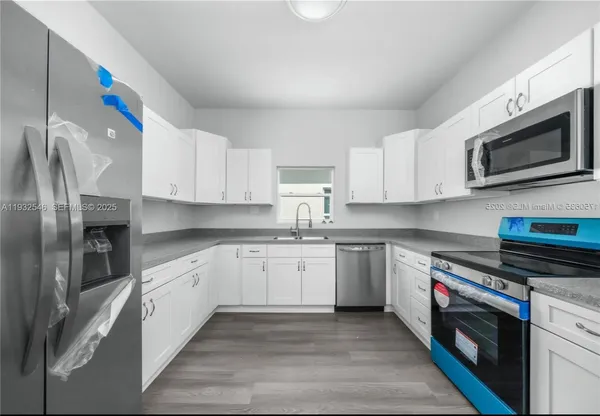 a kitchen with stainless steel appliances granite countertop a sink and a stove