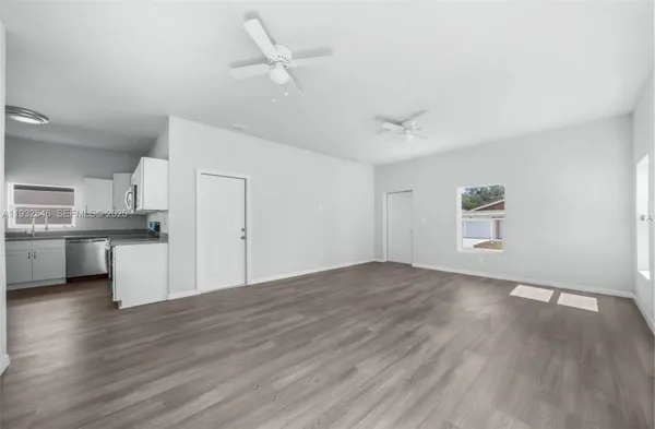 a view of kitchen with wooden floor and window