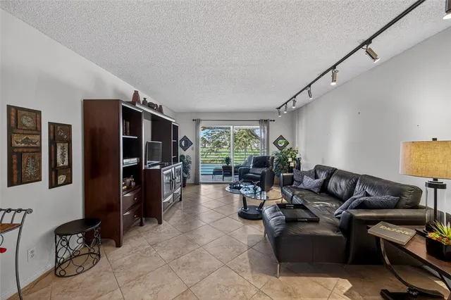 a living room with furniture gym equipment and a window