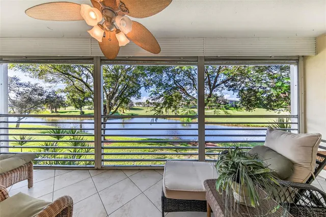 a view of a porch with chairs and a table