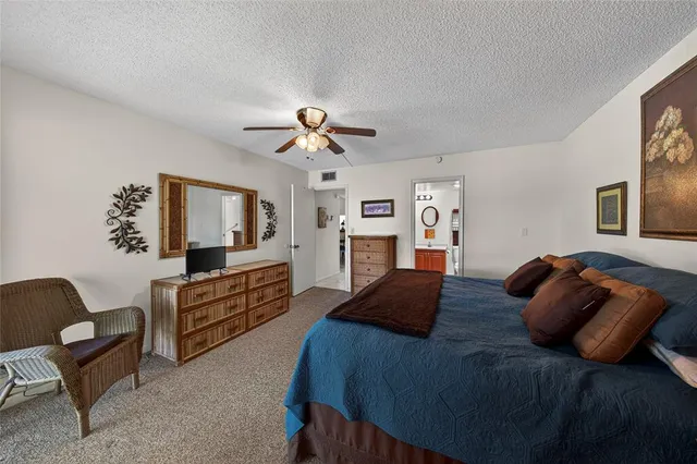 a bedroom with a bed couch and flat screen tv