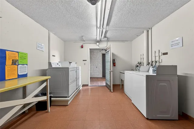 a view of swimming pool with a yard and potted plants