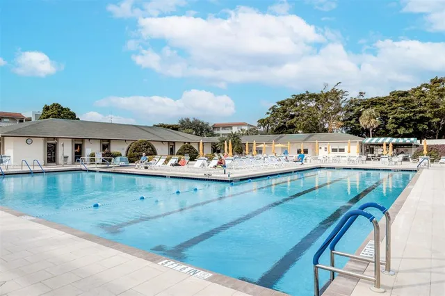 a view of a swimming pool with outdoor seating