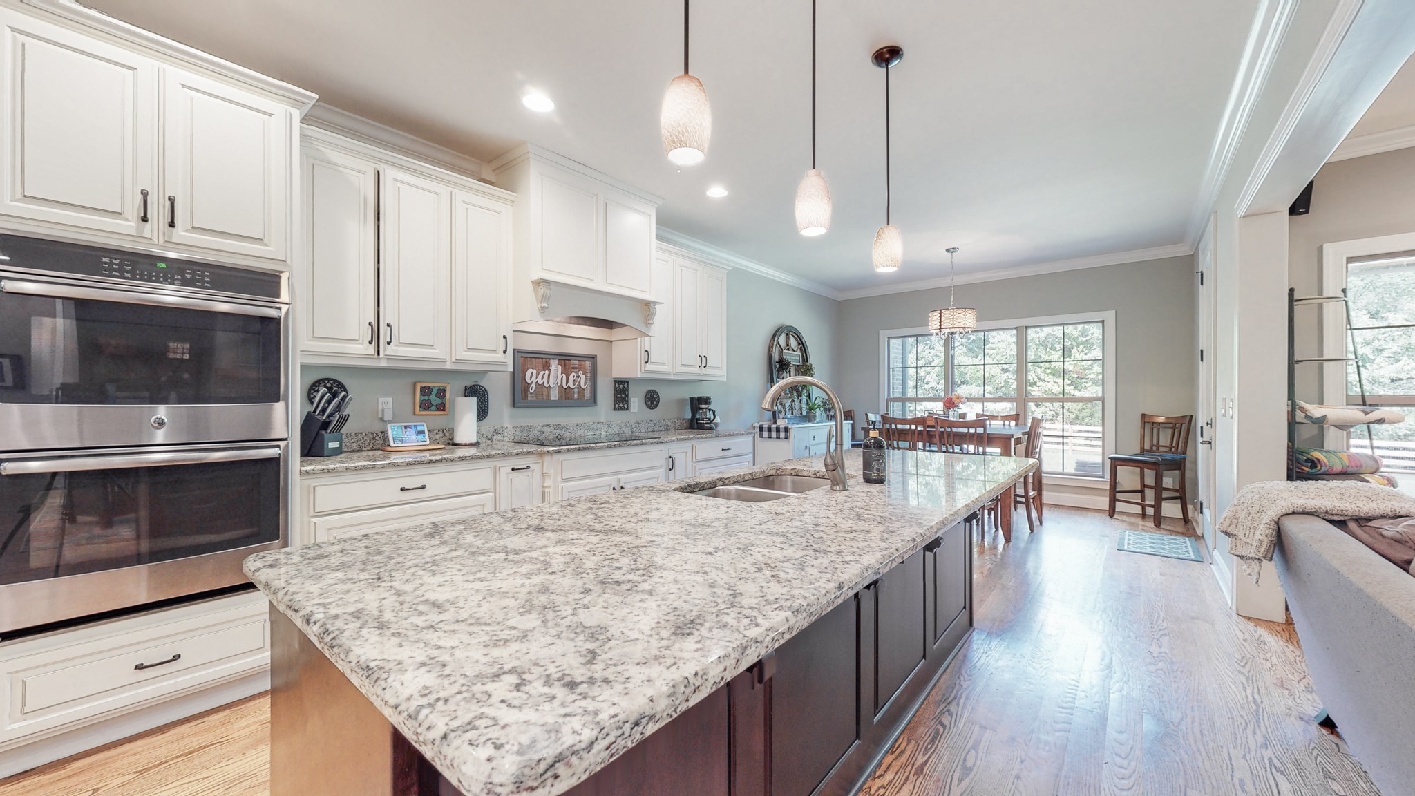 7270 Old Franklin Road Fairview, TN 37062 - Photo 14 of 46 a large kitchen with kitchen island a large counter space a sink appliances and cabinets