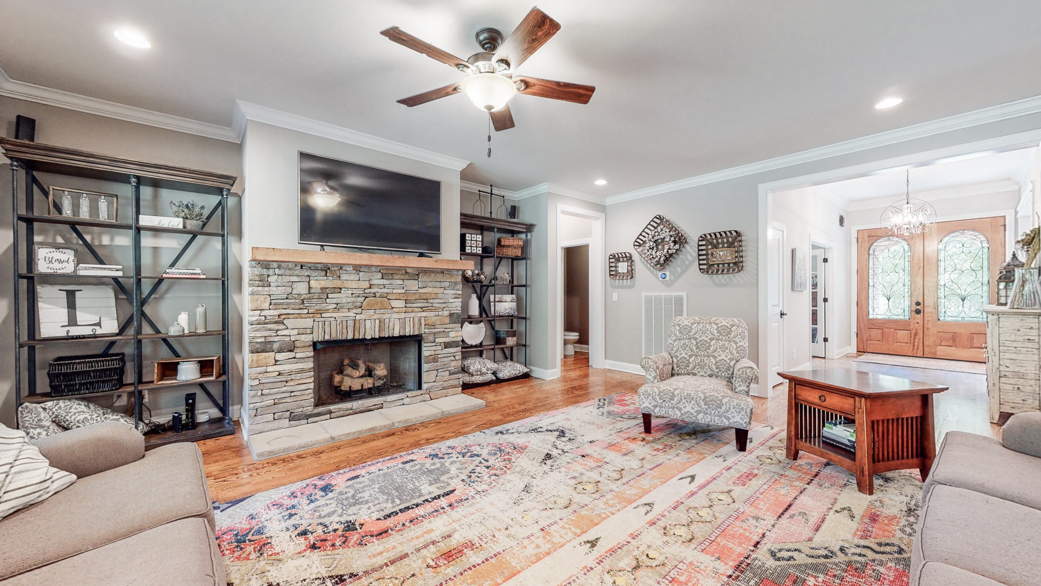 7270 Old Franklin Road Fairview, TN 37062 - Photo 16 of 46 a living room with furniture a flat screen tv and a fireplace