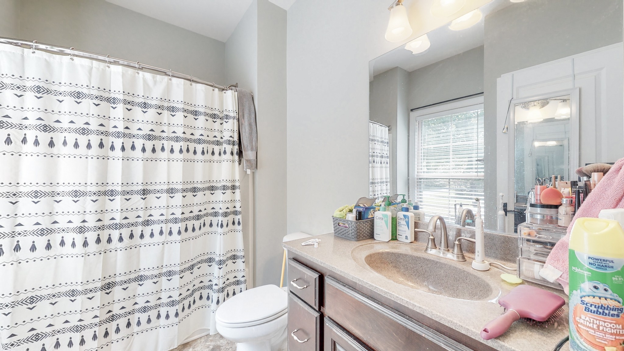 7270 Old Franklin Road Fairview, TN 37062 - Photo 35 of 46 a bathroom with a granite countertop sink a toilet a mirror a vanity and shower