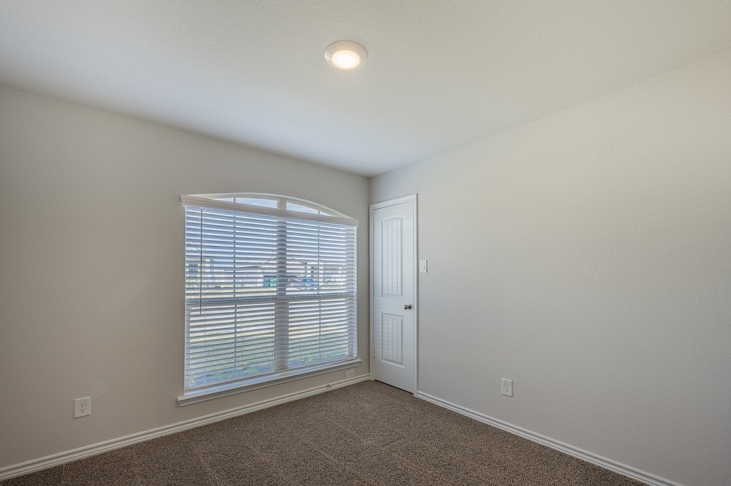 1101 Davy Street Brenham, TX 77833 - Photo 15 of 18 an empty room with windows and closet