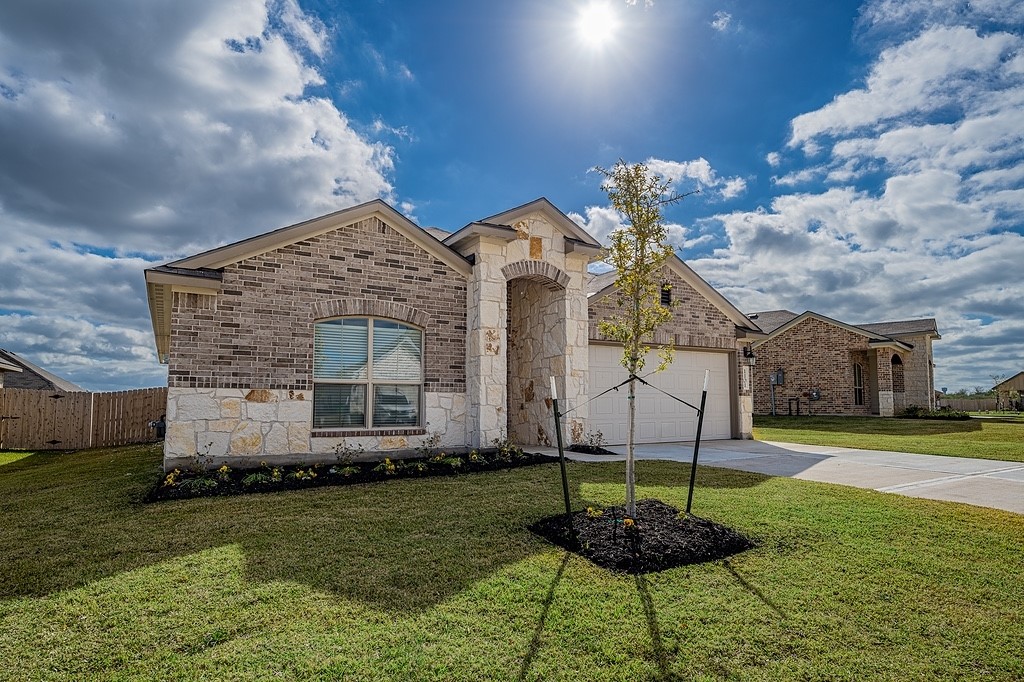 1101 Davy Street Brenham, TX 77833 - Photo 2 of 18 a front view of a house with a yard