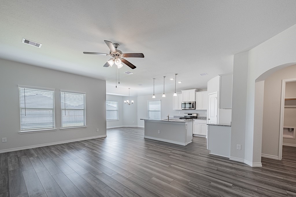 1101 Davy Street Brenham, TX 77833 - Photo 3 of 18 a open kitchen with white cabinets and wooden floor