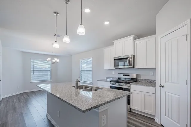 a kitchen with a sink stove and microwave