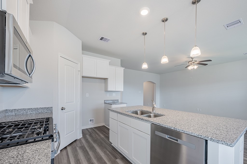 1101 Davy Street Brenham, TX 77833 - Photo 5 of 18 a kitchen with a sink stove and cabinets