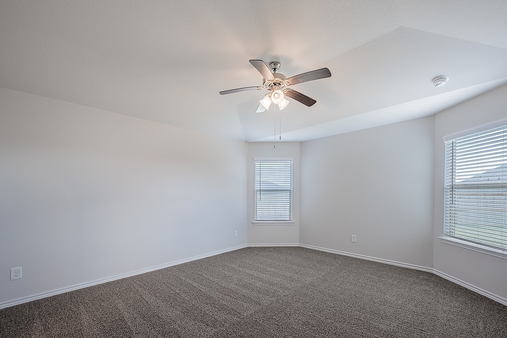 1101 Davy Street Brenham, TX 77833 - Photo 9 of 18 an empty room with windows and fan