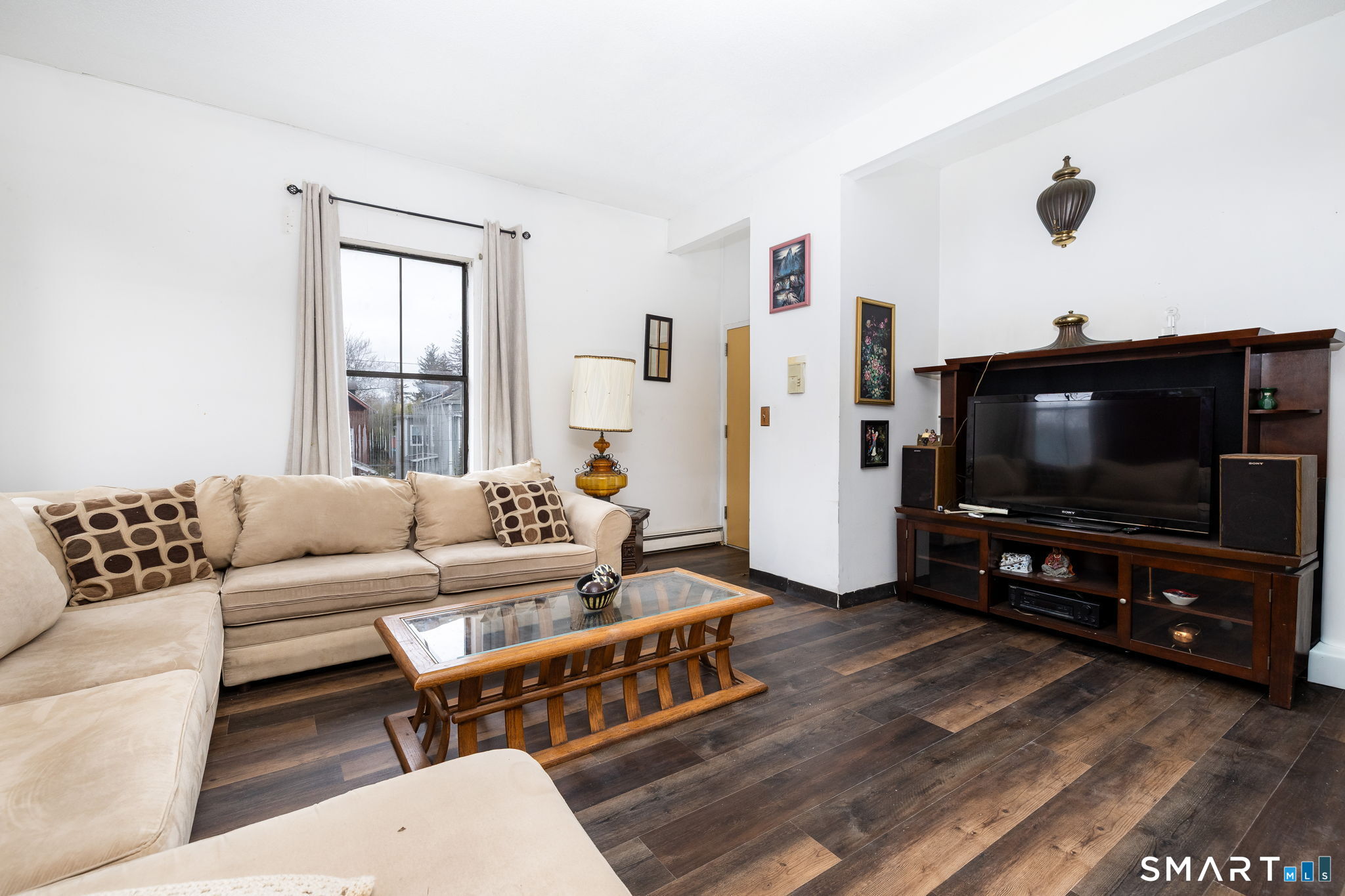 36-38 Capen Street, Unit 2B Hartford, CT 06120 - Photo 4 of 25 a living room with furniture and a flat screen tv