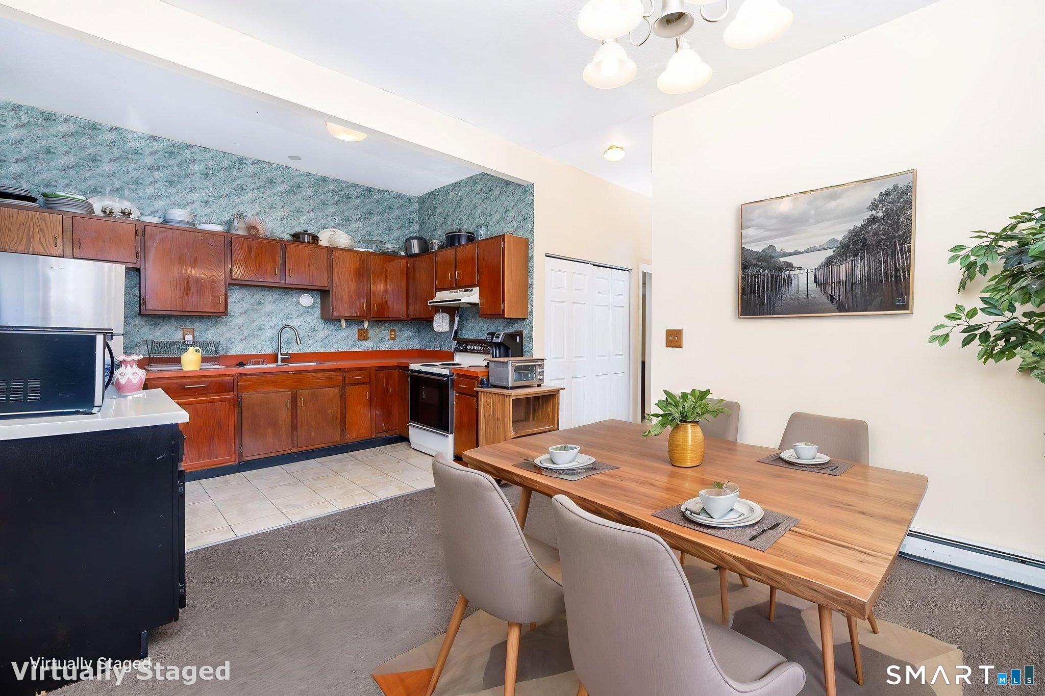 36-38 Capen Street, Unit 2B Hartford, CT 06120 - Photo 9 of 25 a open dining room with stainless steel appliances a table and chairs