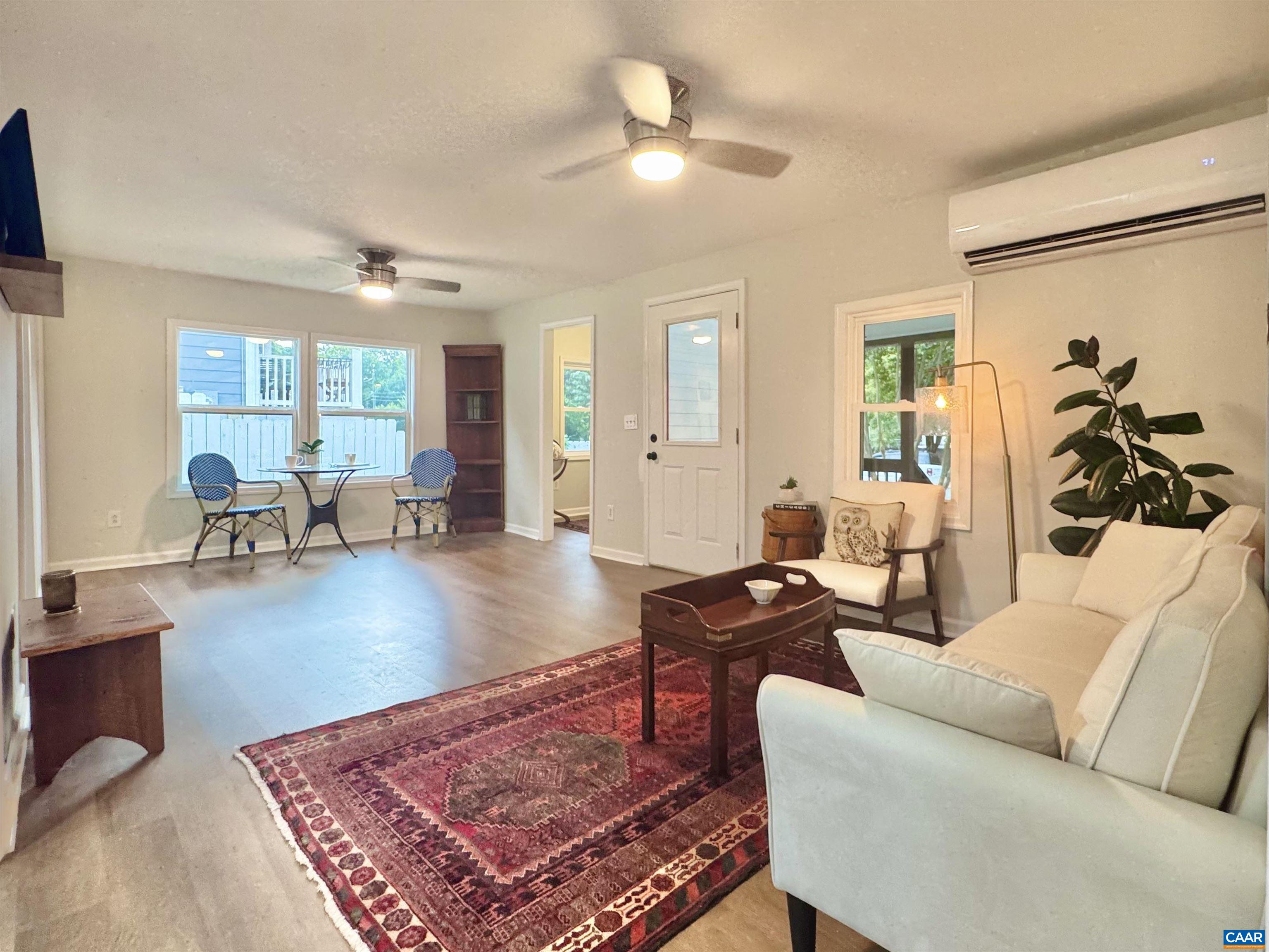 419 Quarry Road Charlottesville, VA 22902 - Photo 2 of 18 a living room with furniture a rug and a large window