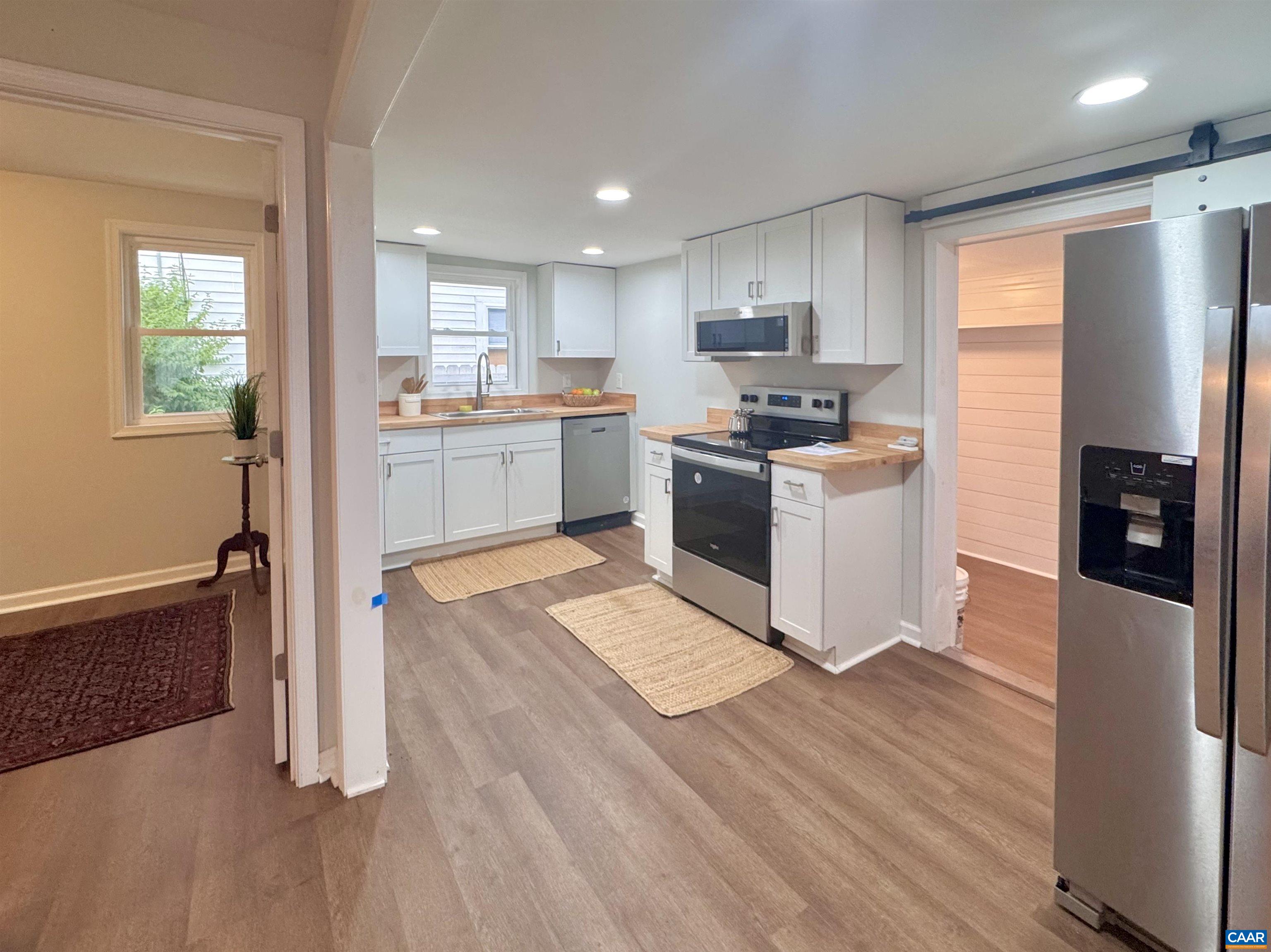 419 Quarry Road Charlottesville, VA 22902 - Photo 6 of 18 a kitchen with granite countertop a refrigerator and a stove top oven