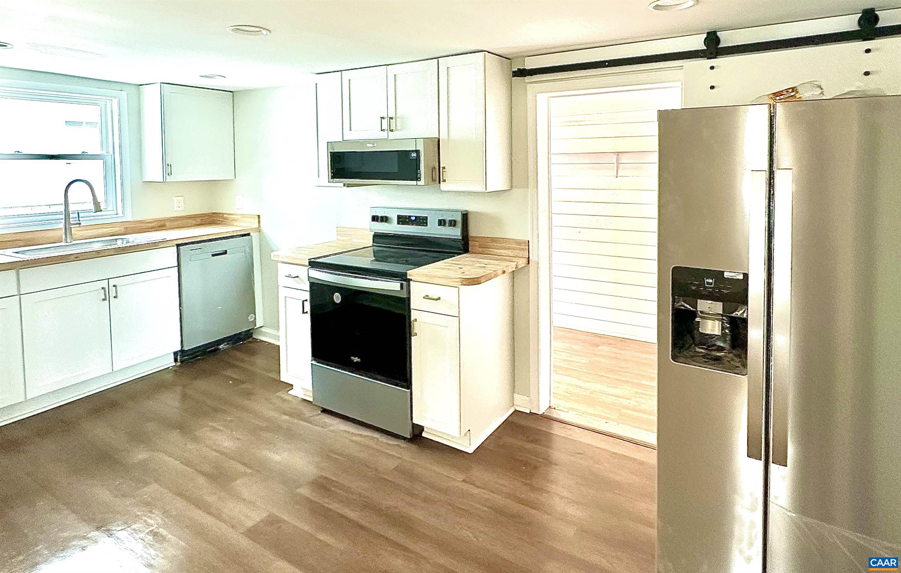 419 Quarry Road Charlottesville, VA 22902 - Photo 7 of 18 a kitchen with stainless steel appliances a stove sink and refrigerator