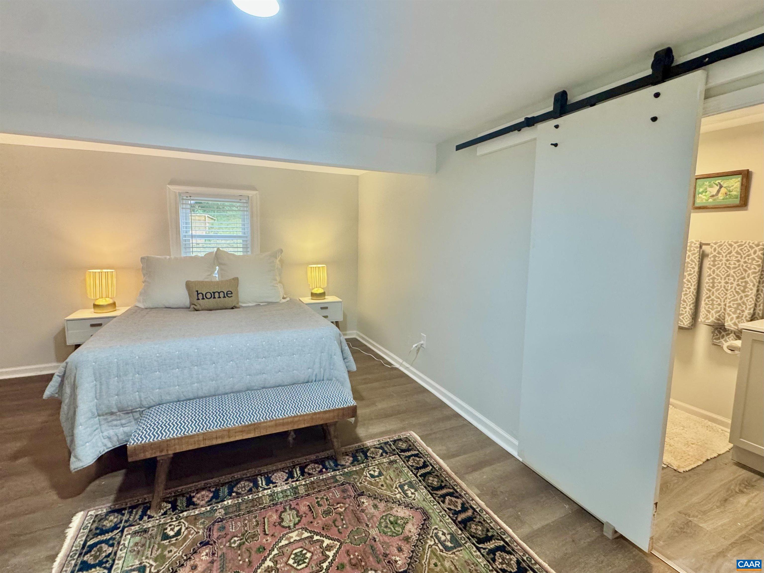 419 Quarry Road Charlottesville, VA 22902 - Photo 8 of 18 a bedroom with a bed and a table in it