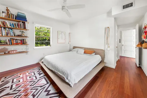 a bedroom with a bed and a book shelf