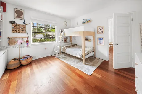 a bedroom with furniture and a wooden floor