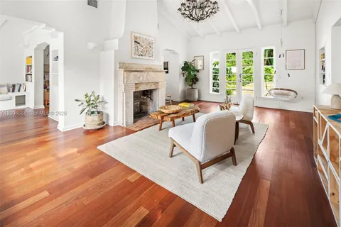 a living room with furniture large window and a fireplace
