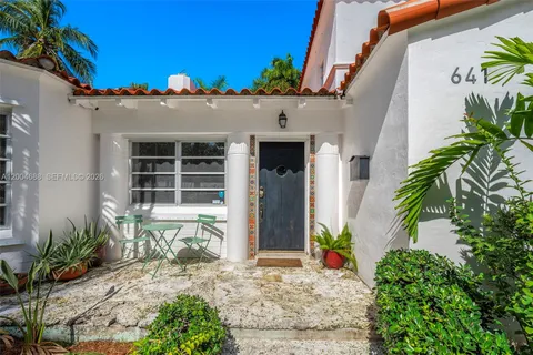 a front view of a house with a potted plant