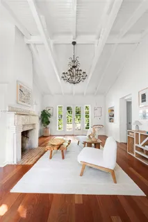 a living room with furniture a fireplace and a chandelier