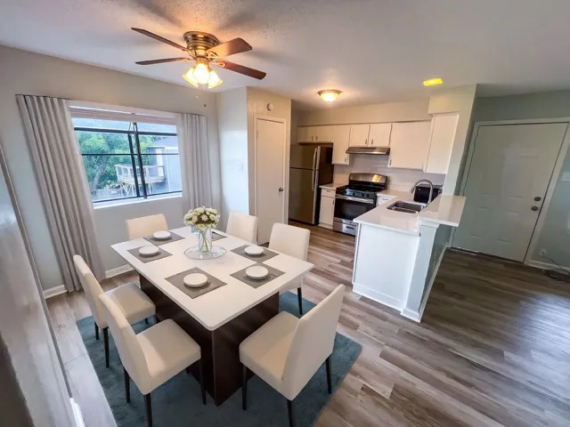 a view of a dining room with furniture window and wooden floor