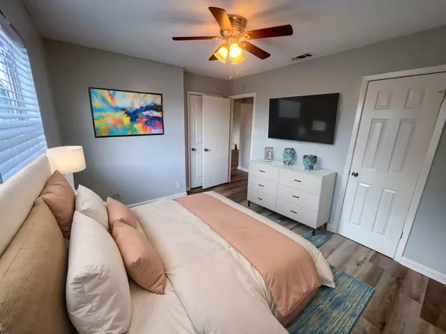 a bedroom with a bed and a flat screen tv