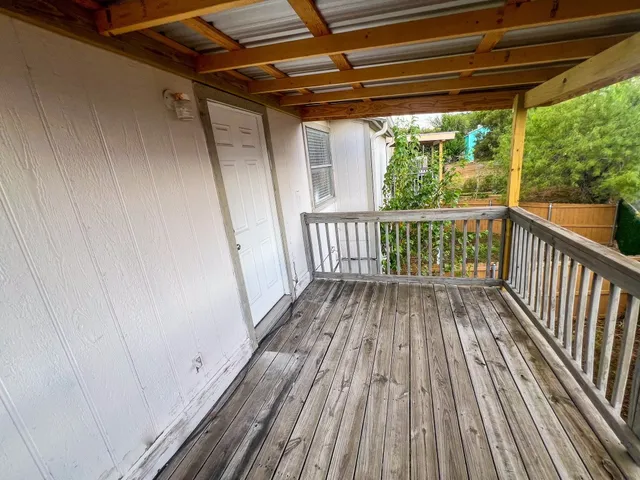 a view of balcony with wooden floor