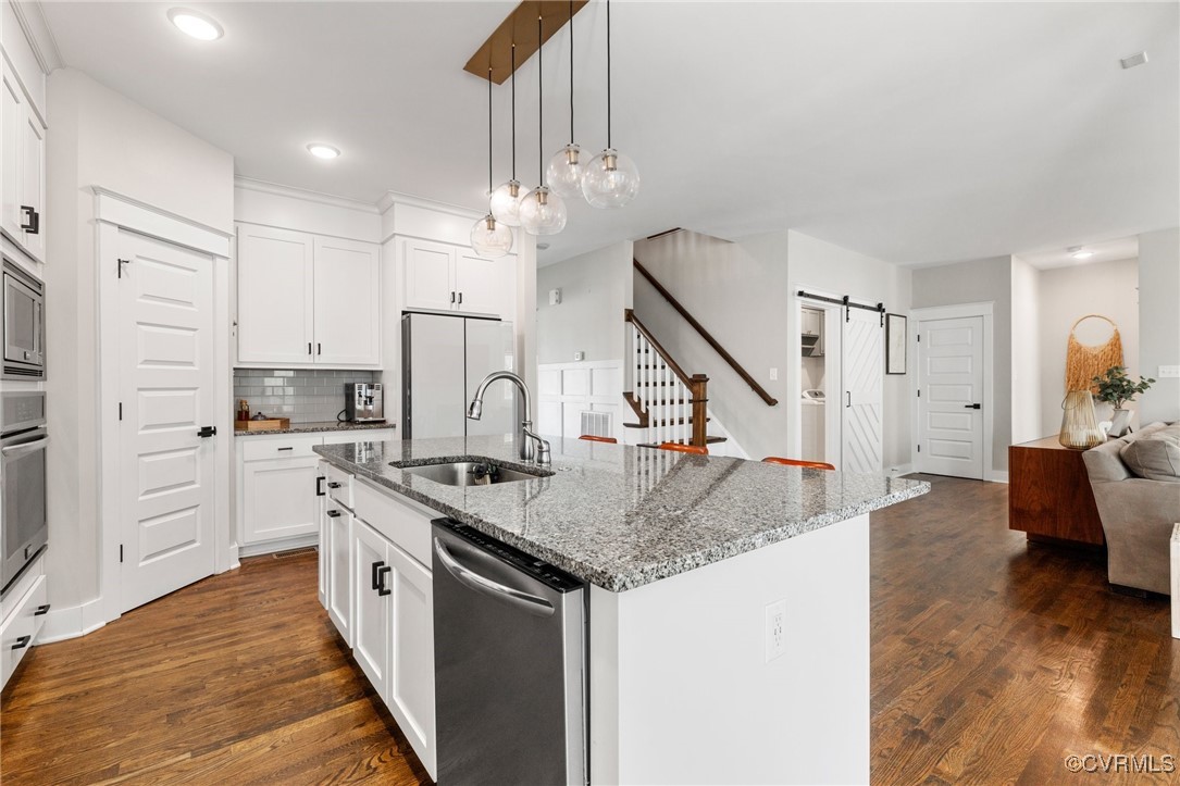3919 Graythorne Drive Midlothian, VA 23112 - Photo 11 of 41 a kitchen with stainless steel appliances granite countertop a sink stove and refrigerator