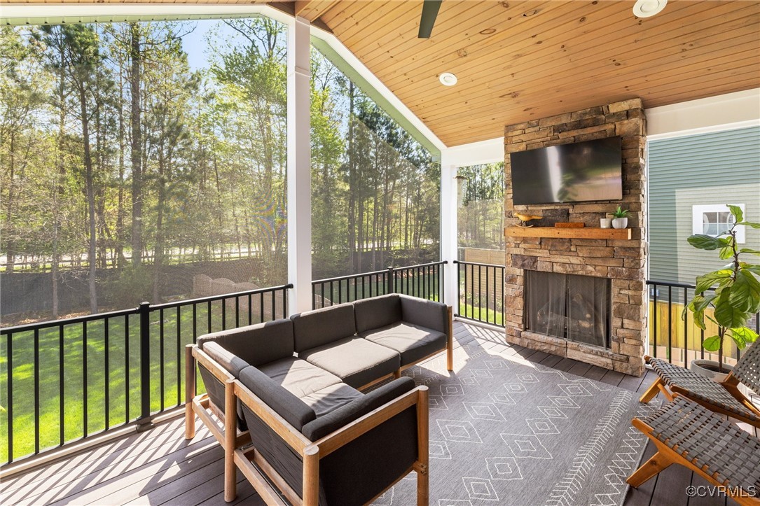 3919 Graythorne Drive Midlothian, VA 23112 - Photo 32 of 41 a living room with furniture a flat screen tv and a floor to ceiling window