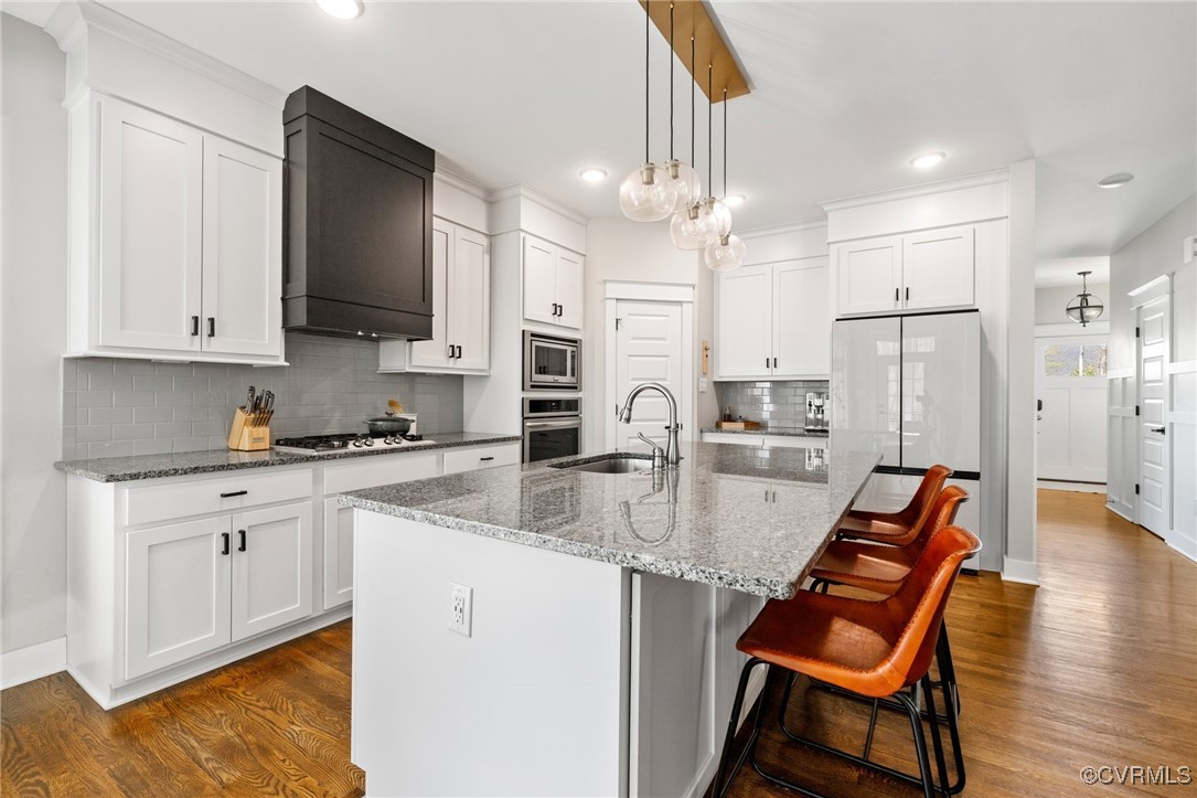 3919 Graythorne Drive Midlothian, VA 23112 - Photo 9 of 41 a kitchen with stainless steel appliances granite countertop a stove refrigerator and a sink